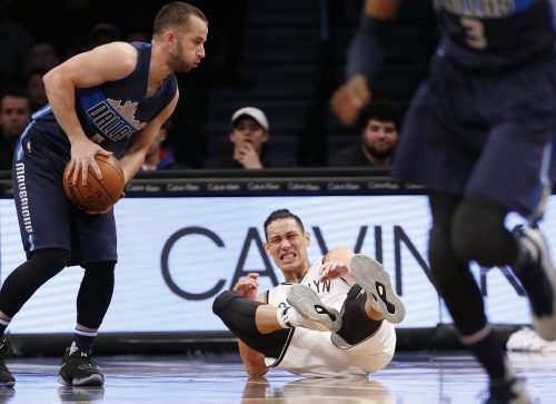 Brooklyn Nets guard Jeremy Lin (7) winces on the floor in the first half of an NBA basketball game against the Dallas Mavericks, Sunday, March 19, 2017, in New York. (AP Photo/Kathy Willens)